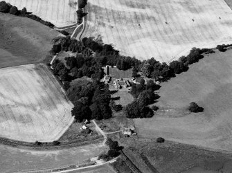 Oblique aerial view of Tarradale House with the cropmarks adjacent, looking to the N.