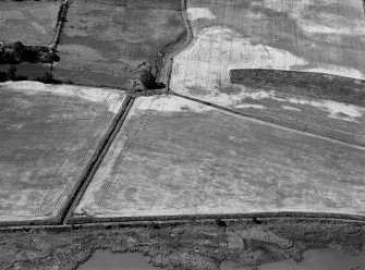 Oblique aerial view centred on the cropmarks of the rectilinear enclosure at Spital Shore, looking to the NW.