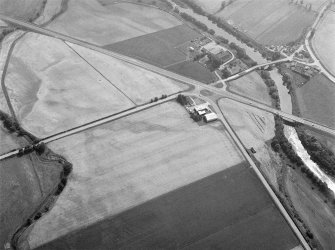 Oblique aerial view centred on North Water Bridge and the A90, looking to the SE.