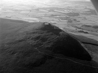 Oblique aerial view centred on the remains of the vitrified fort at Tap O' Noth, looking to the ESE.