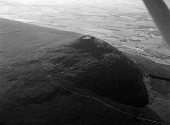 Oblique aerial view centred on the remains of the vitrified fort at Tap O' Noth, looking to the E.