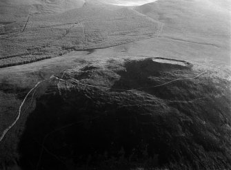 Oblique aerial view centred on the remains of the vitrified fort at Tap O' Noth, looking to the NE.