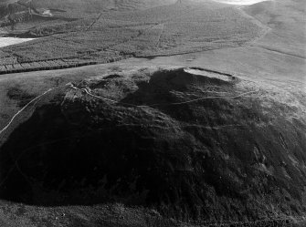 Oblique aerial view centred on the remains of the vitrified fort at Tap O' Noth, looking to the NNE.