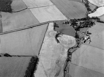 Oblique aerial view centred on the remains of the possible henge or moated site at Roundabout, looking to the SSE.