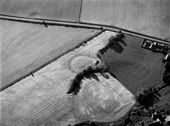 Oblique aerial view centred on the remains of the possible henge or moated site at Roundabout, looking to the S.