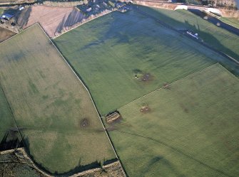 Oblique aerial view centred on the remains of the recumbent stone circle, taken from the SSW.