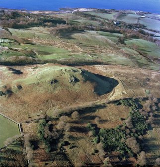 General oblique aerial view centred on the remains of Knock vitrified fort, taken from the ENE.