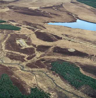 Oblique aerial view centred on the remains of the chambered 
cairns, taken from the WSW.
Digital copy of photograph. 
