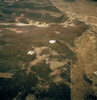 Oblique aerial view centred on the remains of the cairns and boundary stone, taken from the NE.
Digital copy of photograph.