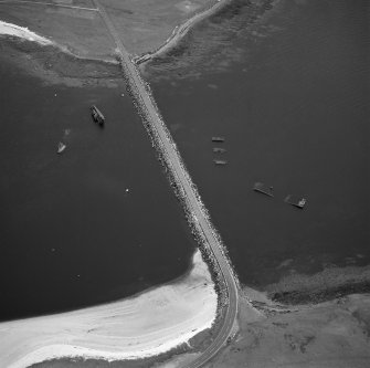 Oblique aerial view from N, centred on the barrier and the wrecks of the blockships Reginald, Empire Seaman and Martis.