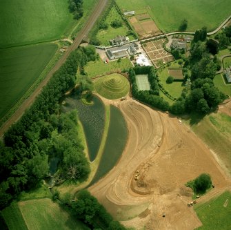 Oblique aerial view centred on Portrack House and garden.