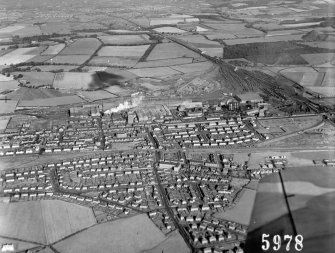 Oblique aerial view centred on the steelworks and Mossend village.