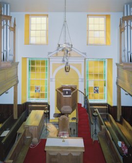 Interior. View from N at gallery level axial view of pulpit and both sets of organ pipes