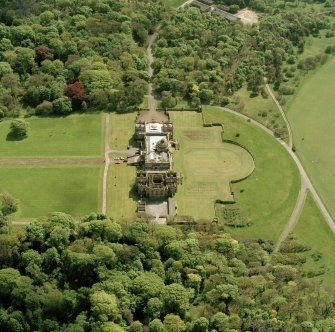 Oblique aerial view of house and formal gardens from SSE.