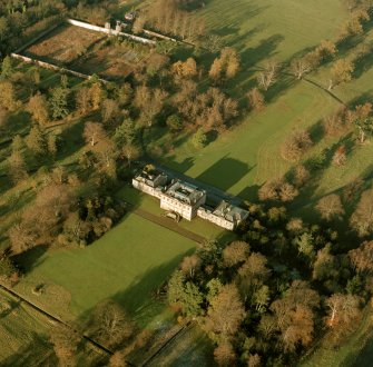 Oblique aerial view, taken from the SW, centred on the country house with the formal garden in the top left-hand corner of the photograph.
