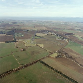 General oblique aerial view looking across the airfield and museum towards the Firth of Forth, taken from the ESE.