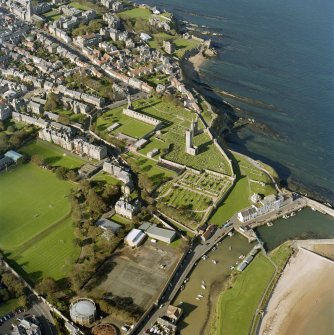 Oblique aerial view centred on the remains of St Andrews cathedral and burial-ground, taken from the SE.