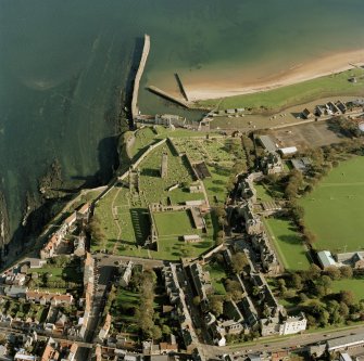 Oblique aerial view of  St Andrews centred on the remains of the cathedral and burial-ground, taken from the WSW.