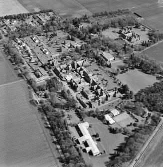 Oblique aerial view centred on the hospital and offices, taken from the WNW.