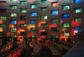 View of seating and stained glass wall in Meeting House chapel.