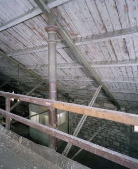 Interior.  4th floor. Timber platform/mezzanine. Detail of cast-iron column and wrought-iron and timber roof structure.