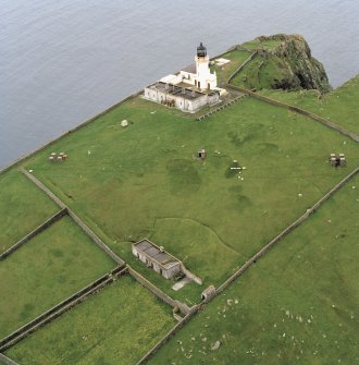 Oblique aerial view centred on Barra Head lighthouse, Berneray, with the remains of the dun adjacent, taken from the NE.