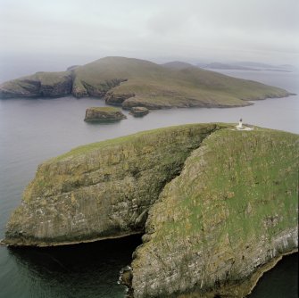 Oblique aerial view of Barra Head lighthouse, Berneray, with the island of Mingulay and those to the N in the background, taken from the SSW.
