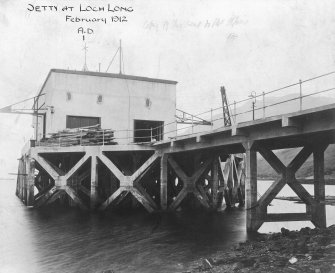 Scanned image of photograph showing pier head building including part of the pier from NE.
Titled 'Jetty at Loch Long'.