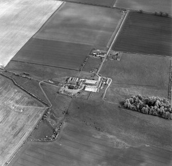 Oblique aerial view centred on the farmsteading with deserted medieval village and rig adjacent, taken from the NW
