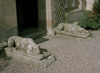 Detail of carved stone dogs flanking entrance to South West block.