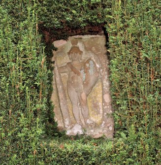 Detail of carved stone set into wall of formal garden.