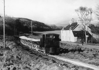 Scanned copy of view of train bringing sand along the shore of Lochaline from the mine to the processing plant at the West Pier (NM64SE 38.01)