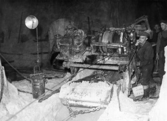 Scanned copy of view of scrape bucket underground, entering loader.