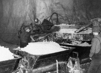 Scanned copy of view of waggons being loaded with silica sand underground.