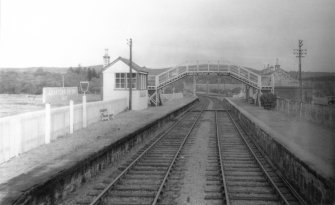 Scanned image of photograph showing Grantown-on-Spey (East) Station signal box and footbridge from N.