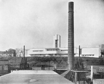 Scanned copy of image from annual report of Miners' Welfare Fund, 1937, Figure 55, Michael Colliery Baths, Fife. The front portion of the building houses the cycle store on the ground floor and the women's baths on the first floor. On the left can be seen the pit locker rooms  and the clean locker rooms (right)