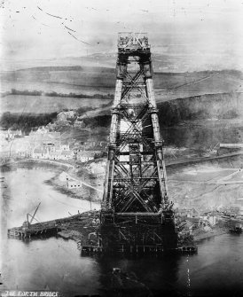 View of the bridge under construction looking from the top of one cantilever to the next.
Insc. 'The Forth Bridge.'