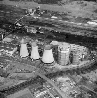 Oblique aerial view centred on Ravenscraig steelworks, Motherwell, in 1991. Since demolished. Here we see the Oower Station (left) and its three cooling towers along with the two gasholders to the right. Engineering Services are in the background (right) and the Ironworks Stores (background left)