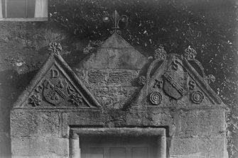 Historic photograph.
Detail of pediments over doorway.
