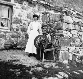 Copy of historic photograph showing portrait of crofters and cottage.