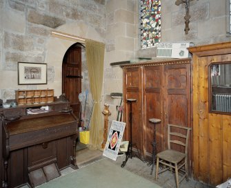 Interior. Vestry View from N showing cupboards and harmonium