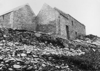 Digital image of photograph labelled 'Film No. 55/81/13. 1.11.1981. View looking south at Mill of Skail, Sandwick, Mainland, Orkney, HY 233 188. To right; grain mill, to left; threshing mill. Between legs - water wheel & at corner is site of building which fell down in c1921.'

