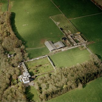 Oblique aerial view centred on the country house and walled garden with the farmsteading adjacent, taken from the SSW.