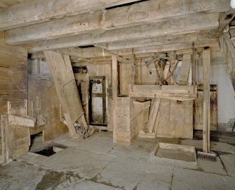 Interior. Ground floor. Main  milling area (W part of structure). N end of room. Detail showing fanner, bucket elevator, gear cupboard with sieve in front.
