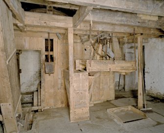 Interior. Ground floor. Main  milling area (W part of structure). N end of room. Detail showing gear cupboard with sieve in front.