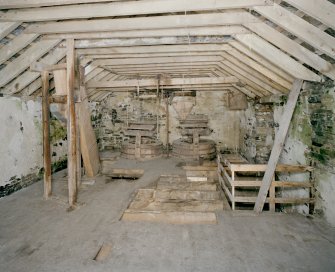 Interior. 1st floor. Main milling floor. View from S showing conveyor frame, grain elevator, stones and stairs.