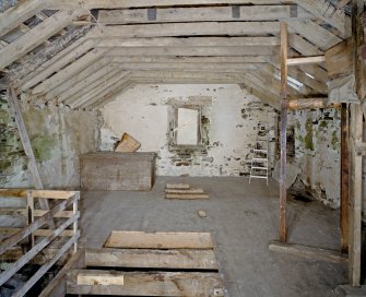 Interior. 1st floor. Main milling floor. View from NW showing grain cist, roof structure and grain conveyor frame.