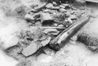 Excavation photographs: Horizontal timber in moat; presumed to form part of bridge of 13th Century castle at Old Caerlaverock Castle.