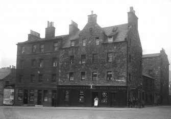 View of the front of No. 98 - 104 St Leonard's Street, Edinburgh, including Castle o' Clouts Spirit Vaults (no.104)  and a tobacconist and confectioner shop (no.98) from the south west