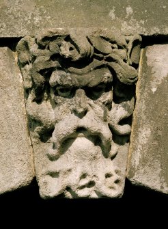 South facade, east pavilion, detail of carved head over arch